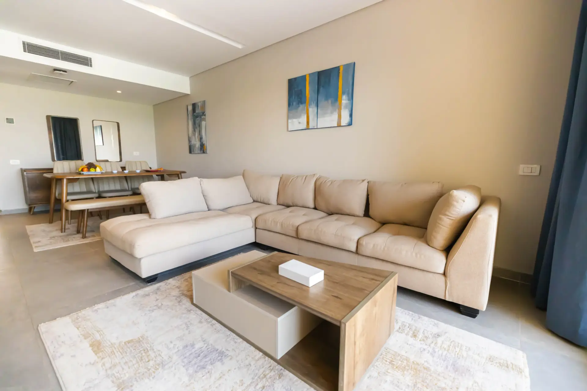Living room of the Master Suite at V Grand Sahl Hasheesh with large corner sofa, coffee table and dining area